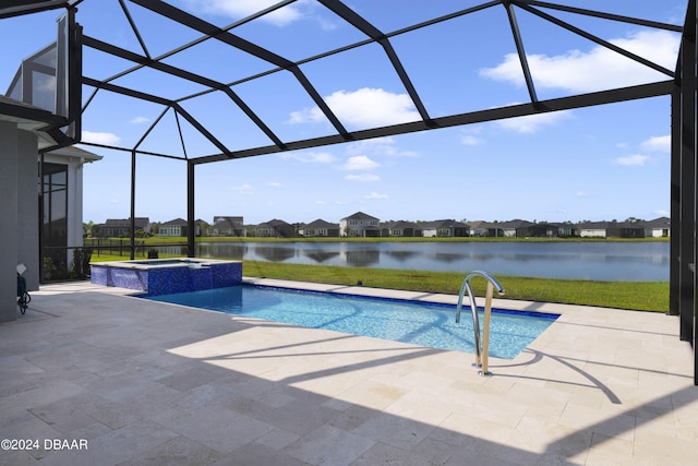 view of pool with glass enclosure, a water view, a patio, and an in ground hot tub