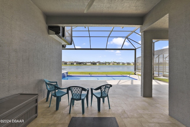 view of patio / terrace with a water view and a lanai