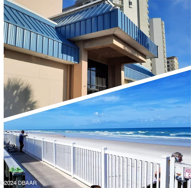 exterior space with a water view and a beach view