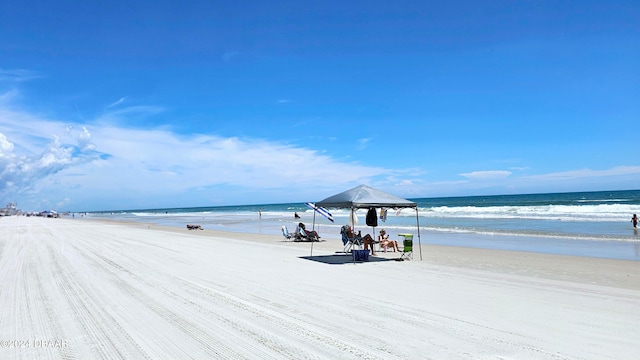 view of water feature with a beach view and a gazebo