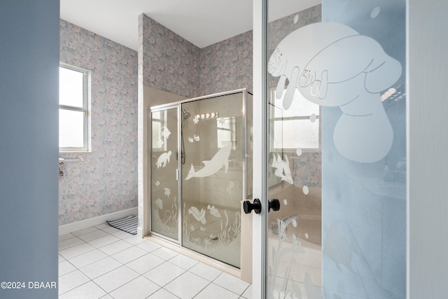 bathroom with tile patterned floors and a shower with door