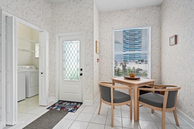 tiled foyer entrance featuring washer and dryer