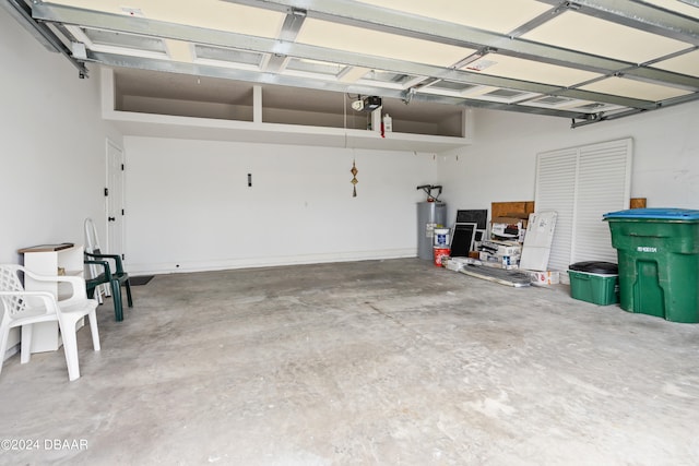 garage featuring electric water heater and a garage door opener