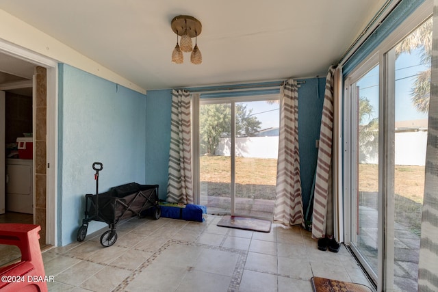 interior space with washer / clothes dryer and a wealth of natural light