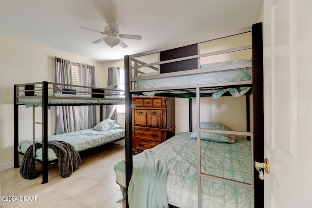 tiled bedroom featuring ceiling fan