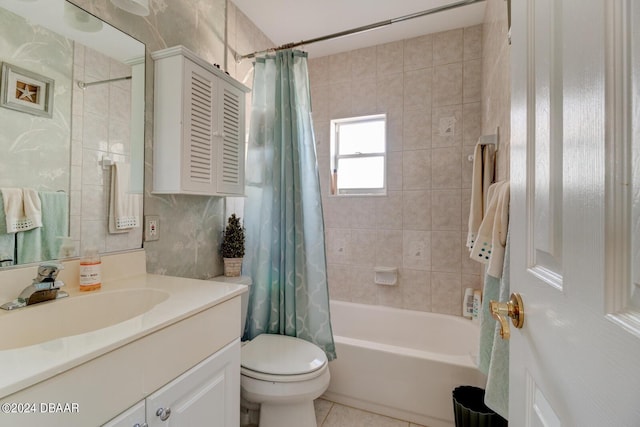 37 Poinsettia Dr, Ormond Beach, FL 32176 - full bath featuring vanity, toilet, shower / bathtub combination with curtain, tile patterned flooring, and tile walls