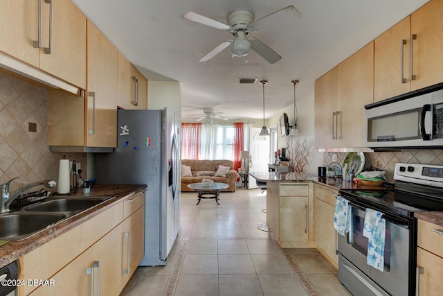 37 Poinsettia Dr, Ormond Beach, FL 32176 - kitchen with appliances with stainless steel finishes, light brown cabinetry, a sink, a ceiling fan, and open floor plan