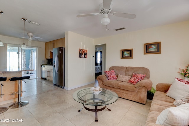 tiled living room with ceiling fan