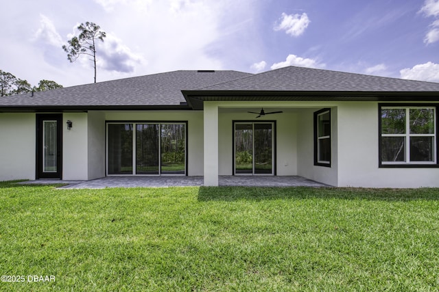 rear view of property with ceiling fan, a patio area, a shingled roof, and stucco siding
