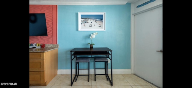 miscellaneous room with light tile patterned floors and ornamental molding