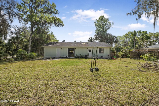 2249 Swoope Dr, New Smyrna Beach, FL 32168 - back of property featuring a lawn and fence