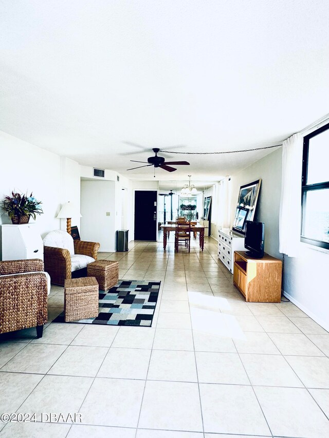 tiled living room with ceiling fan