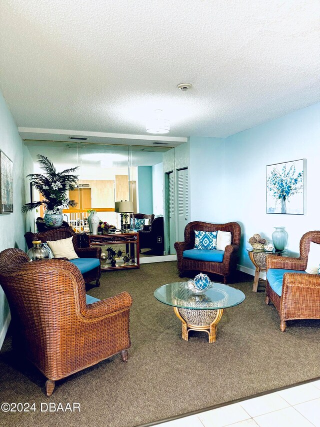 living room featuring a textured ceiling and carpet floors