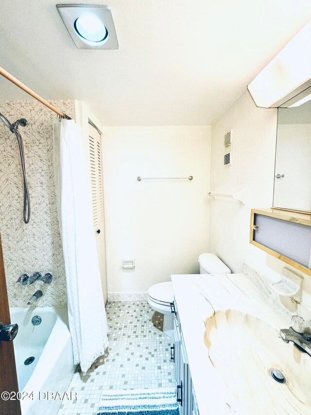 full bathroom featuring tile patterned flooring, vanity, toilet, and shower / tub combo with curtain