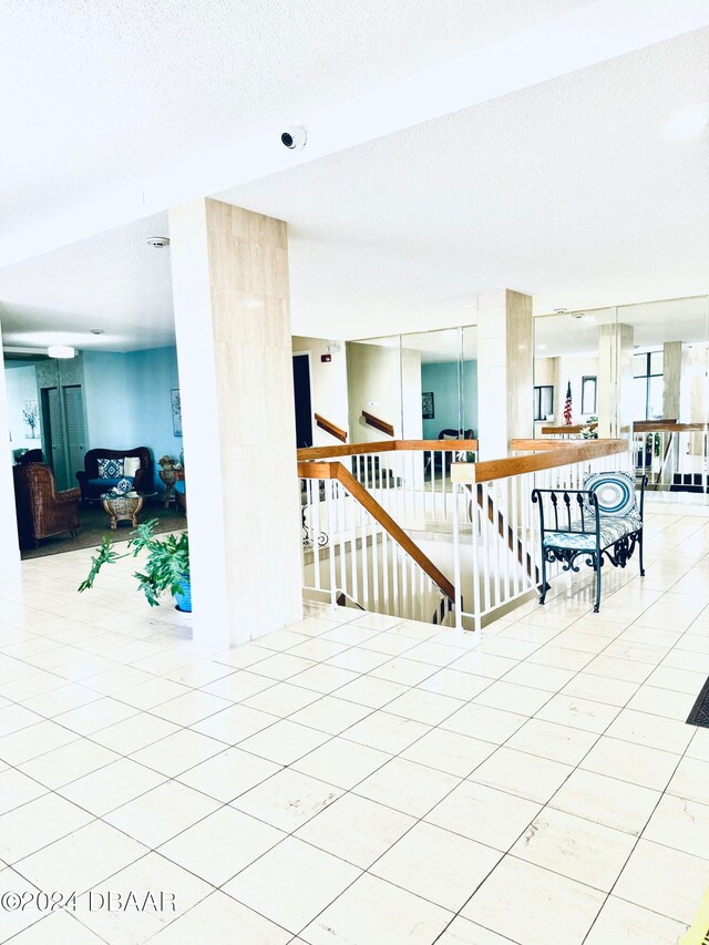 interior space with a textured ceiling and tile patterned floors