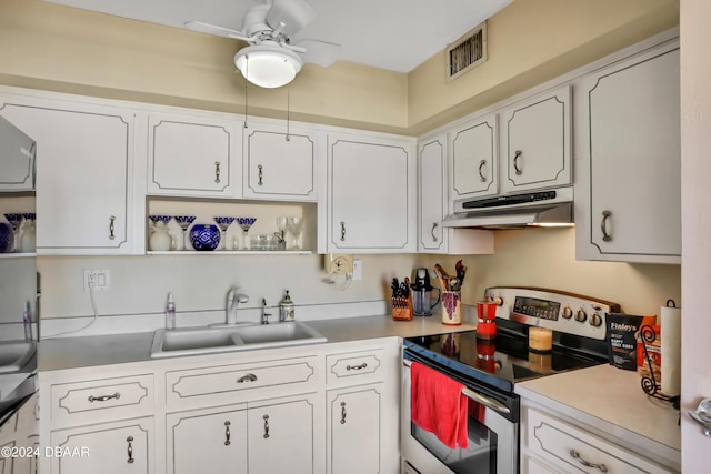 335 N Causeway Cswy Unit E220, New Smyrna Beach, FL 32169 - kitchen featuring electric stove, under cabinet range hood, a sink, and white cabinets