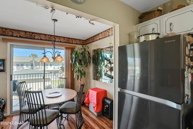 335 N Causeway Cswy Unit E220, New Smyrna Beach, FL 32169 - dining room with wood finished floors and a chandelier