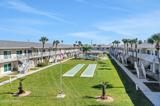 335 N Causeway Cswy Unit E220, New Smyrna Beach, FL 32169 - view of home's community featuring stairway, shuffleboard, a residential view, and a lawn