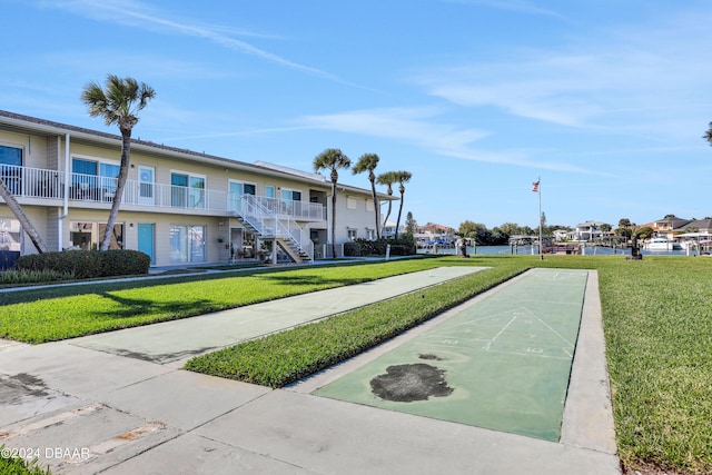 335 N Causeway Cswy Unit E220, New Smyrna Beach, FL 32169 - view of home's community with shuffleboard, a lawn, and a water view