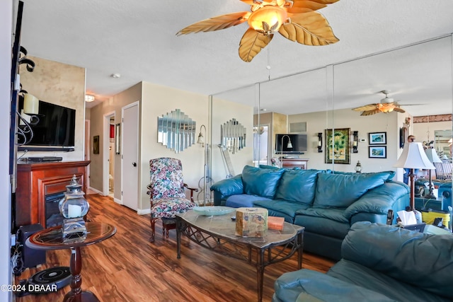 living room with wood-type flooring and ceiling fan