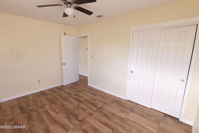 unfurnished bedroom featuring wood-type flooring, a closet, and ceiling fan