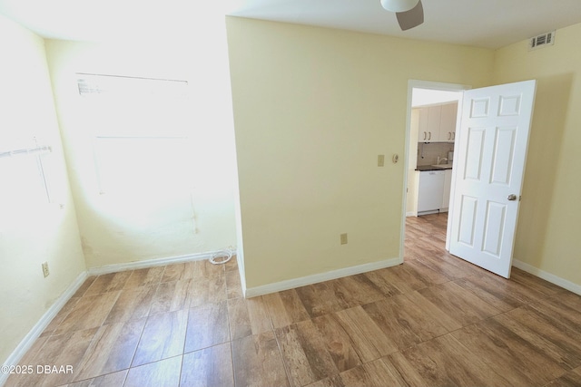 spare room with ceiling fan and light hardwood / wood-style floors