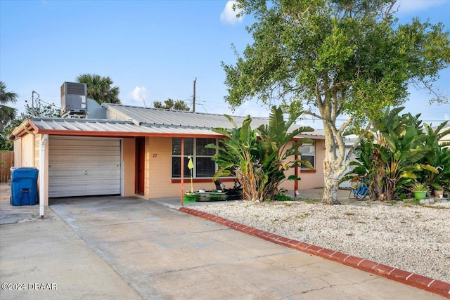 single story home with central AC and a garage