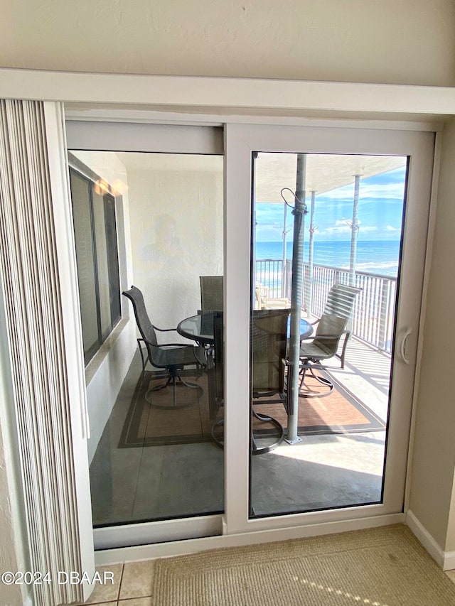 entryway with a water view and tile patterned flooring