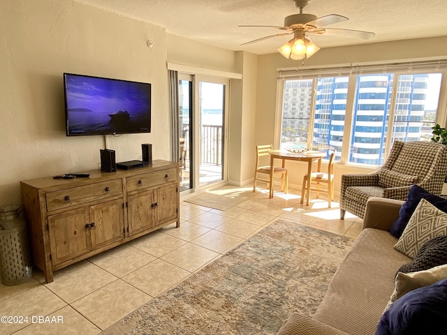 2615 S Atlantic Ave Unit 6G, Daytona Beach Shores, FL 32118 - living area with ceiling fan, light tile patterned floors, a textured ceiling, and baseboards