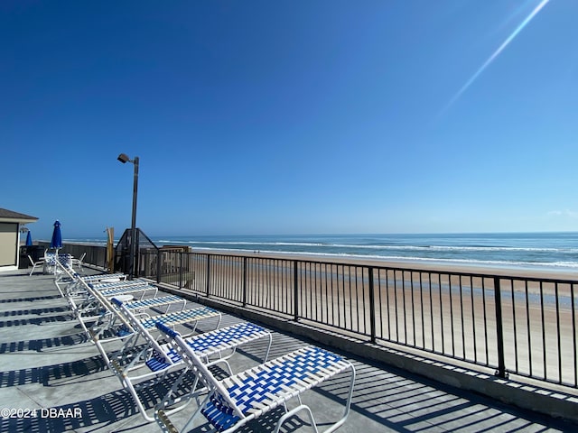 exterior space with a water view and a view of the beach