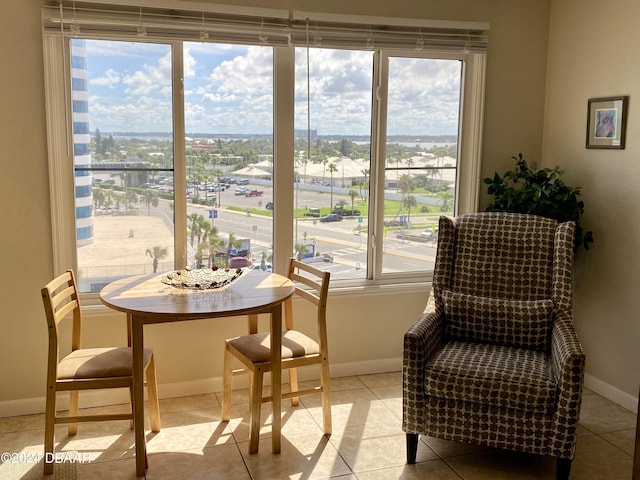 2615 S Atlantic Ave Unit 6G, Daytona Beach Shores, FL 32118 - living area with healthy amount of natural light, baseboards, and light tile patterned floors