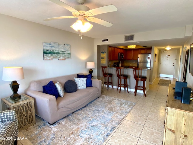 living room with ceiling fan and light tile patterned floors