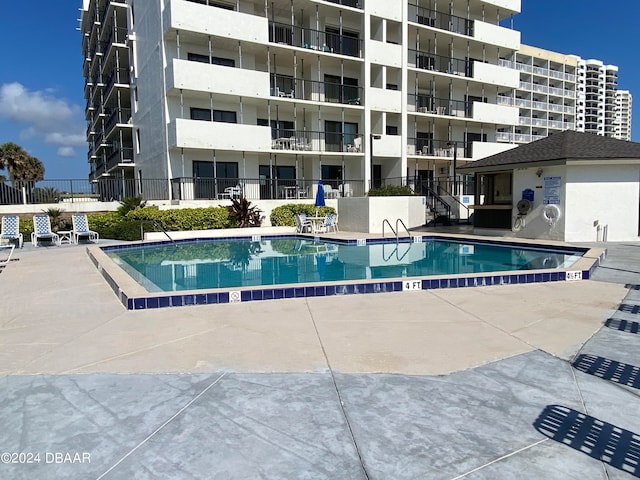 view of swimming pool with a patio area