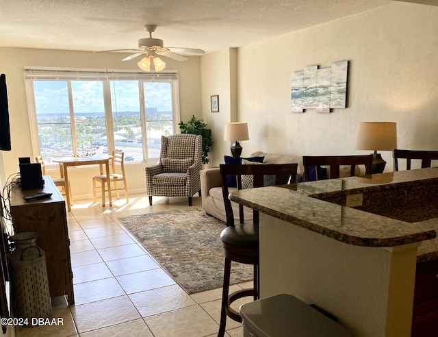 2615 S Atlantic Ave Unit 6G, Daytona Beach Shores, FL 32118 - dining area with a ceiling fan, light tile patterned floors, and a textured ceiling
