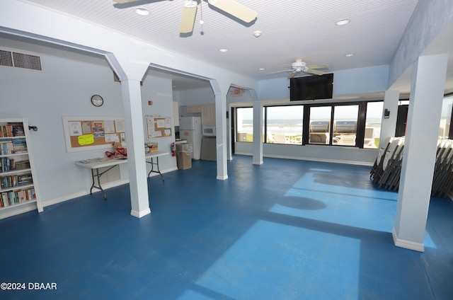 exercise area with ceiling fan and decorative columns