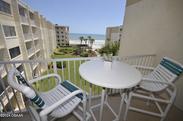 balcony featuring a beach view and a water view