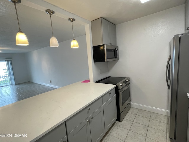 kitchen with gray cabinets, appliances with stainless steel finishes, and pendant lighting