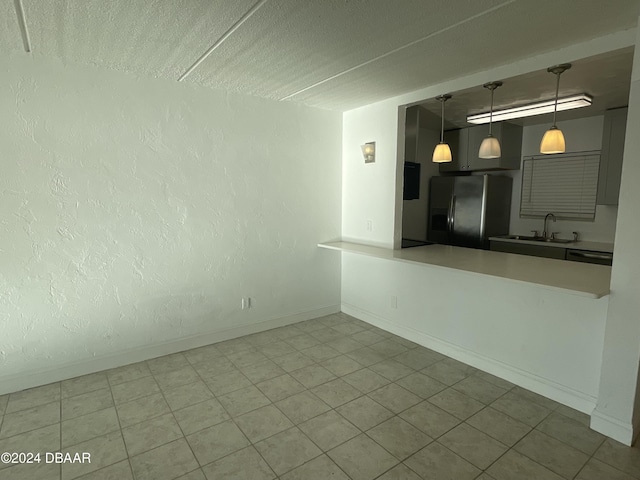 kitchen with stainless steel fridge with ice dispenser, decorative light fixtures, sink, and dishwasher