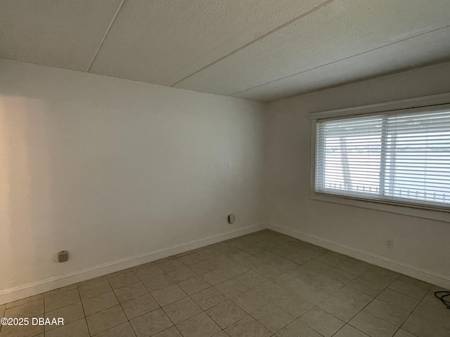 unfurnished room featuring a textured ceiling