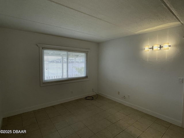 spare room with a textured ceiling