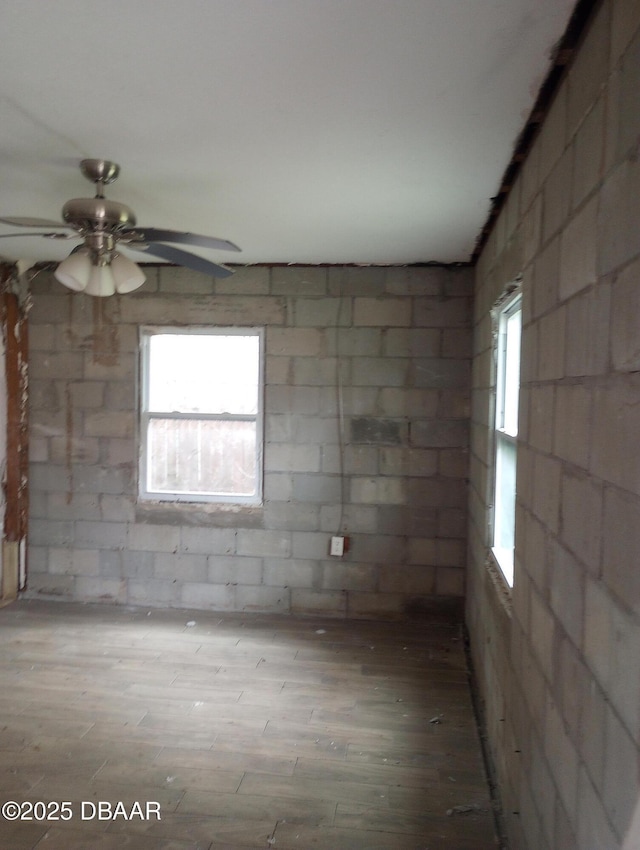 empty room with ceiling fan and hardwood / wood-style flooring