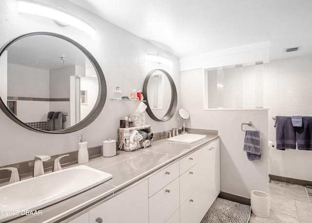 bathroom featuring heating unit and vanity