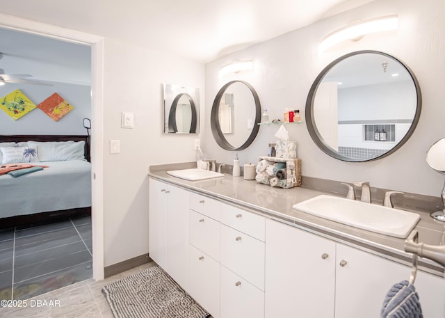 bathroom with tile patterned flooring, ceiling fan, and vanity