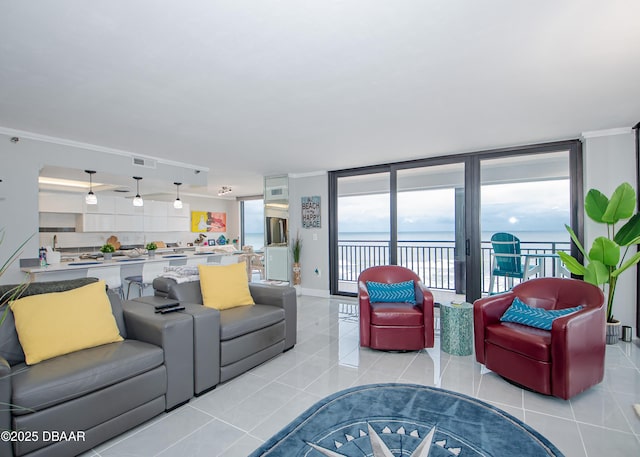 tiled living room with crown molding and a water view