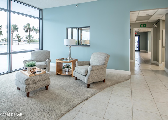 living area featuring light tile patterned floors and floor to ceiling windows