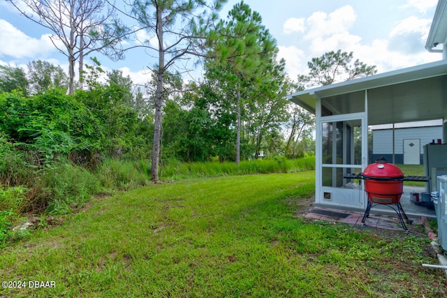 view of yard with a sunroom