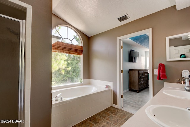 bathroom featuring separate shower and tub, vanity, a textured ceiling, and hardwood / wood-style flooring