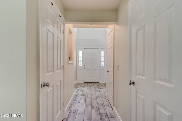 hall with light hardwood / wood-style floors