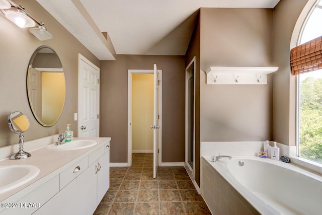 bathroom featuring vanity and independent shower and bath