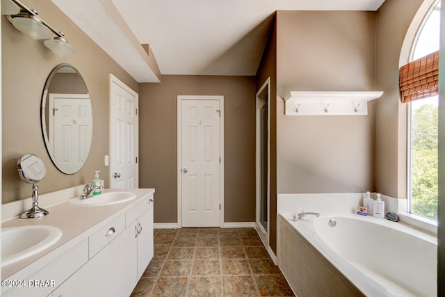 bathroom featuring vanity and independent shower and bath